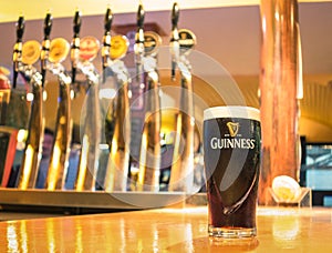 Pint of Guinness beer served in a pub.