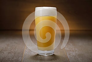 A pint of IPA, hazy unfiltered juicy draft NEIPA beer on wooden background photo