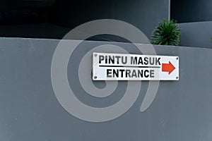 Pintu masuk mean Entrance. Entrance sign on the wall wrote in Bahasa pintu masuk