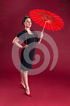 Pinup Girl in Black Dress Haughty with Red Parasol