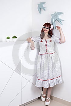 Pinup girl with classic white dress with dots