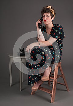 Pinup Girl in Flowered Outfit Bored on the Phone