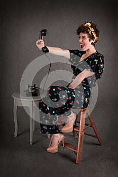 Pinup Girl in Flowered Outfit Excited with Phone Information