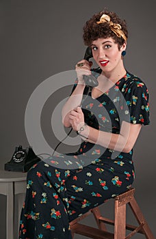 Pinup Girl in Flowered Outfit on The Phone Looks Surprised