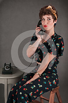 Pinup Girl in Flowered Outfit Smirks with Phone