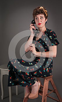 Pinup Girl in Flowered Outfit Waits on the Line
