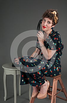 Pinup Girl Looks Exasperated While on Old Phone photo