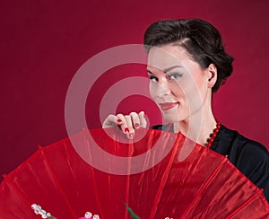 Pinup Girl Looks Over Red Parasol