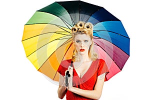 Pinup girl with rainbow umbrella at rain weather. Rainy autumn mood, pin up woman red dress isolated white.