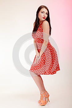 Pinup girl woman in retro dress blowing a kiss