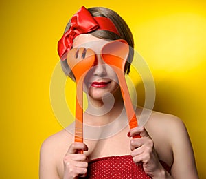 Pinup style housewife with kitchen utensils