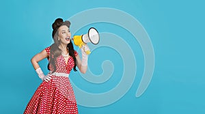Pinup woman in retro outfit making announcement, shouting into megaphone on blue background, banner with free space