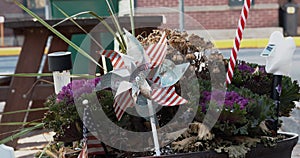 Pinwheel and american flag decorations in flower pot