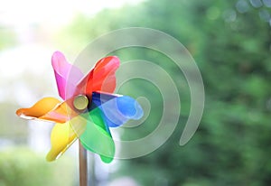 Pinwheel,windmill,toy mill on green blurred background empty copy space
