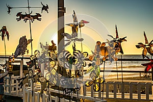 Pinwheels spinning on pier