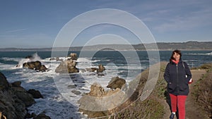 Piont Lobos Woman on trail scenic landscapes of Big Sur coast of the pacific ocean