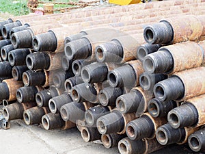 Pipe for Drilling rigs for oil and gas on background. Drilling of oil and gas wells.