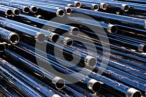 Pipe for Drilling rigs for oil and gas on background. Drilling of oil and gas wells.