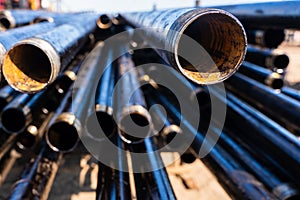 Pipe for Drilling rigs for oil and gas on background. Drilling of oil and gas wells.