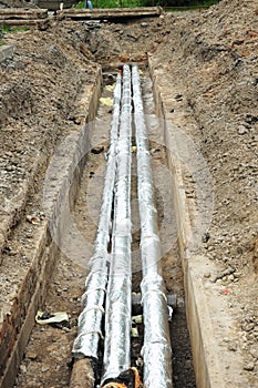 Pipe insulation. Breakthrough sewerage system.Pipes for water in an earthen trench.