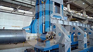 Pipe manufacturing plant. Iron pipe welding. Sparks of welding. Tap. Factory. Machine tools. Production. Heavy industry.
