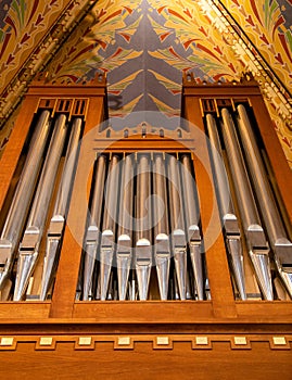 Pipe organ frontal shot, shiny silver prospect pipes pattern, row closeup. Sacral music, church musical service and