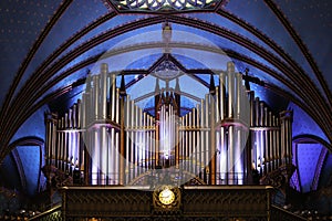 Pipe organ inside the Catholic church -  ancient decoration, Gothic style, stained glass windows. Montreal Notre Dame Basilica