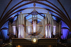 Pipe organ inside the Catholic church -  ancient decoration, Gothic style, stained glass windows. Montreal Notre Dame Basilica