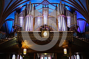 Pipe organ inside the Catholic church -  ancient decoration, Gothic style, stained glass windows. Montreal Notre Dame Basilica