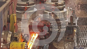 Pipe production, red hot pipes at the factory. Pipe mill