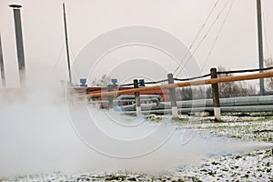 Pipe rack with pipes in superheated high-pressure steam at an oil refinery petrochemical chemical plant photo