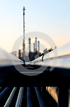 pipe and silhouette of oil refinery