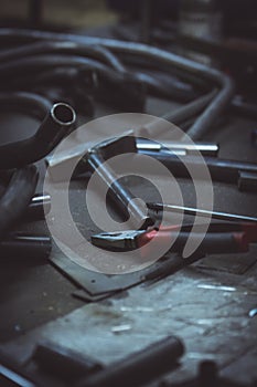 Pipe and tools on a work surface in a metalwork manufacturing.