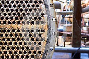 Pipe tube sheet or plate of heat exchanger or boiler part with flange closeup corrosion texture over out of focus