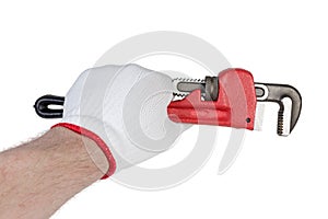 Pipe wrench in hand in protective glove on white background