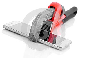 Pipe wrench holding smart mobile phone.