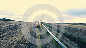 Pipeline construction. Tractor pipelayer lays a gas pipeline. Construction of a new gas pipeline. Photo from a