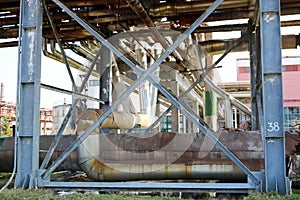 Pipeline estocada, pipes with steam and condensate, pipeline trestle with blue beams in oil refinery, petrochemical, chemical