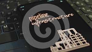 Pipeline infrastructure inscription on smartphone screen with black background. Graphic presentation with oil refinery