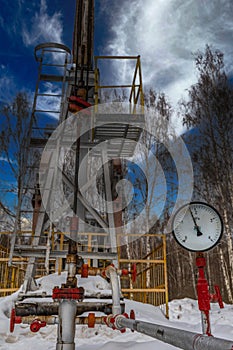 Pipeline Manometer Oil pressure gauge shows 1,8 MPa Max 3 MPa - red line Oil pumpjack winter working. Oil rig energy industrial