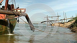 Pipeline pumping system on boat for sand dredging. Piping system going down river 