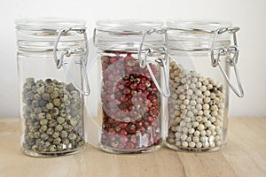 Piper nigrum fruit, white, green, pepper and Schinus molle, American false pink pepper and right green an white pepper