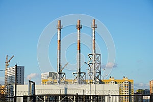 Pipes against the blue sky in a row. White gas heating pipes, in a city without smoke