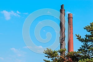 Pipes of a factory against the sky in the city of Kotka in Finland