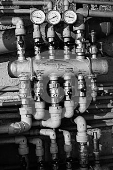 Pipes and levers controls central heating system of house in black and white