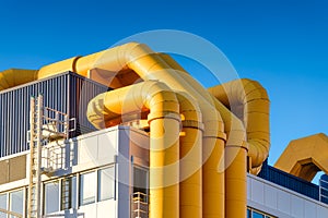 Pipes at an oil refinery. Industrial photo for background. Manufacturing and manufactory. Bright pipes against the blue sky.