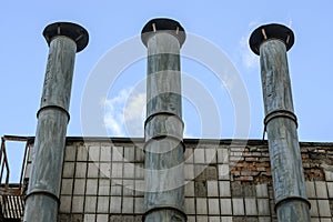 Pipes of the old boiler room against the blue sky. Abstract industrial background.