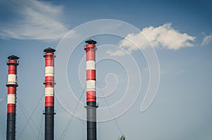 Pipes of the plant against the background of the sky/production