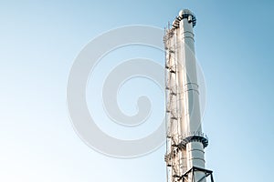 Pipes of the plant against the blue sky