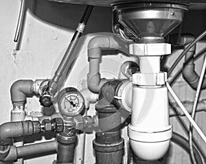 Pipes and plumbing under the sink